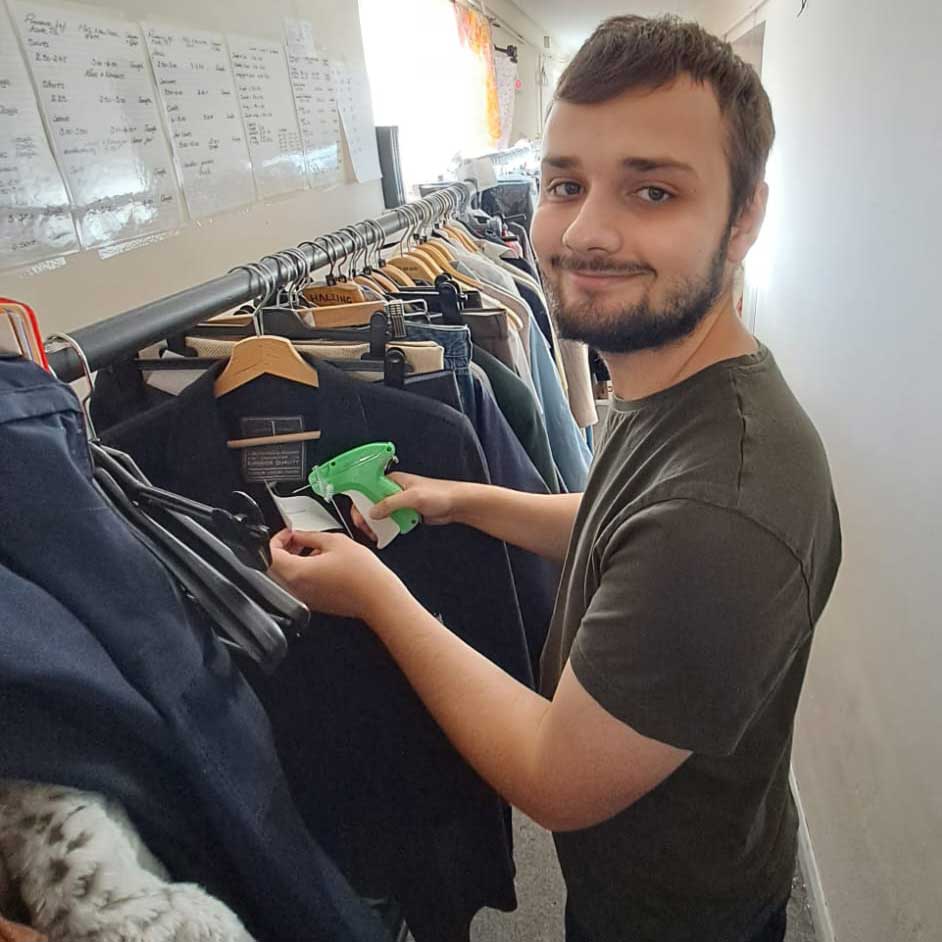 Tristan pricing clothes after getting a job using our into work service