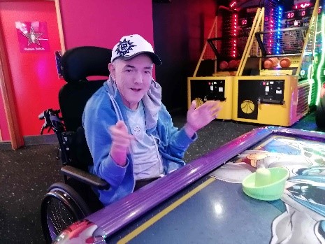 Malkom in a gaming arcade for learning disability week